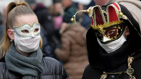 Участники карнавала в Венеции в защитных масках