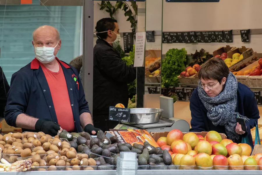 Женщина делает покупки в продуктовом магазине в Париже