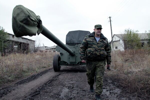 Военнослужащий у военной техники, отведенной от линии соприкосновения ДНР, на специально подготовленной площадке в Донецкой области Военнослужащий у военной техники, отведенной от линии соприкосновения ДНР, на специально подготовленной площадке в Донецкой области
