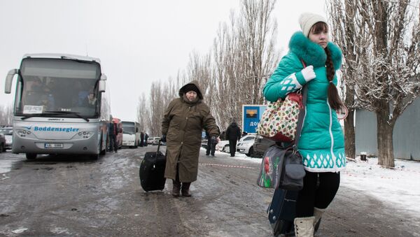 Пожилая женщина с девочкой у пропускного пункта в Донецкой области на границе Украины с Россией. Архивное фото Пожилая женщина с девочкой у пропускного пункта в Донецкой области на границе Украины с Россией. Архивное фото