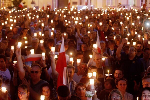 Протестующих держат свечи перед Верховным судом во время протеста в Варшаве. 16 июля 2017 Протестующих держат свечи перед Верховным судом во время протеста в Варшаве. 16 июля 2017
