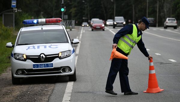 Сотрудник ДПС во время дежурства на одной из автодорог в Московской области. Архивное фото Сотрудник ДПС во время дежурства на одной из автодорог в Московской области. Архивное фото