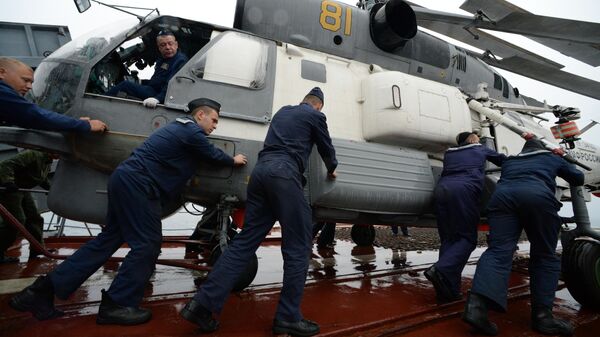 Моряки готовят к полёту вертолёт Ка-27 во время совместных российско-японских учений по поиску и спасению на море Сарекс-2019 Моряки готовят к полёту вертолёт Ка-27 во время совместных российско-японских учений по поиску и спасению на море Сарекс-2019