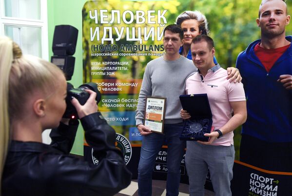 Победители Всероссийских соревнований Человек идущий фотографируются после награждения Победители Всероссийских соревнований Человек идущий фотографируются после награждения