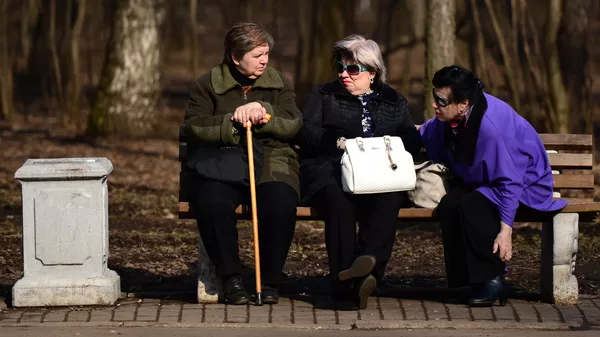 Пожилые женщины отдыхают на скамейке в парке