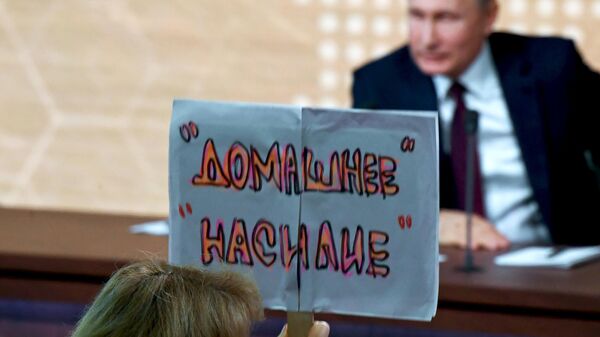 Журналист с плакатом Домашнее насилие во время большой ежегодной пресс-конференции президента РФ Владимира Путина Журналист с плакатом Домашнее насилие во время большой ежегодной пресс-конференции президента РФ Владимира Путина