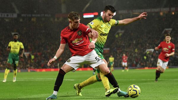 Norwich City's Scottish defender Grant Hanley (R) challenges Manchester United's English defender Brandon Williams (L) during the English Premier League football match between Manchester United and Norwich City at Old Trafford in Manchester, north west England, on January 11, 2020. (Photo by Oli SCARFF / AFP) / RESTRICTED TO EDITORIAL USE. No use with unauthorized audio, video, data, fixture lists, club/league logos or 'live' services. Online in-match use limited to 120 images. An additional 40 images may be used in extra time. No video emulation. Social media in-match use limited to 120 images. An additional 40 images may be used in extra time. No use in betting publications, games or single club/league/player publications. / Norwich City's Scottish defender Grant Hanley (R) challenges Manchester United's English defender Brandon Williams (L) during the English Premier League football match between Manchester United and Norwich City at Old Trafford in Manchester, north west England, on January 11, 2020. (Photo by Oli SCARFF / AFP) / RESTRICTED TO EDITORIAL USE. No use with unauthorized audio, video, data, fixture lists, club/league logos or 'live' services. Online in-match use limited to 120 images. An additional 40 images may be used in extra time. No video emulation. Social media in-match use limited to 120 images. An additional 40 images may be used in extra time. No use in betting publications, games or single club/league/player publications. /