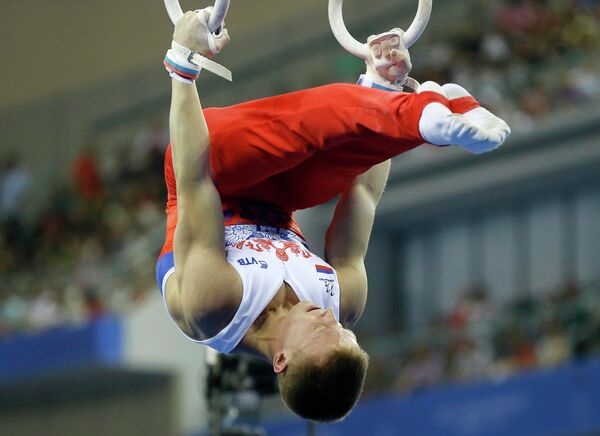 Денис Аблязин выступает в упражнении на кольцах на чемпионате мира по спортивной гимнастике Денис Аблязин выступает в упражнении на кольцах на чемпионате мира по спортивной гимнастике
